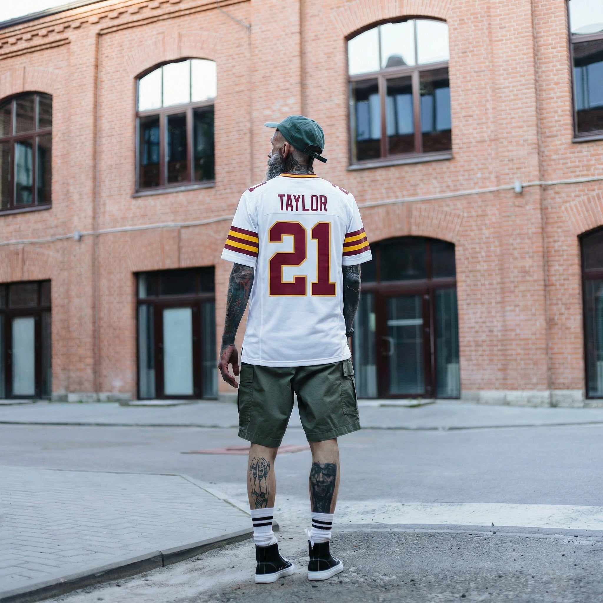 Person wearing a sports jersey with 'Taylor 21' in an urban setting